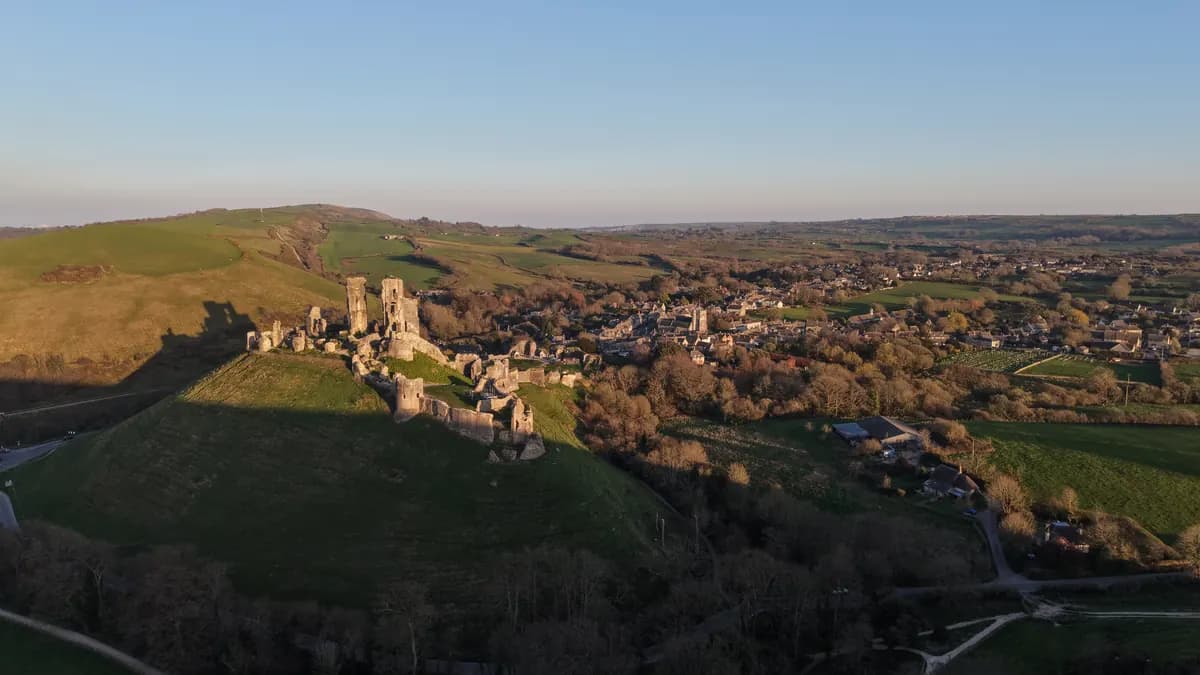 Aerial view of Corfe Castle and the surrounding Dorset landscape